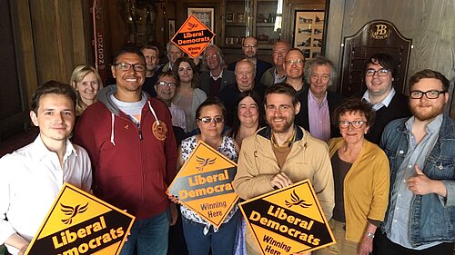 A group of Sunderland Lib Dems holding diamond posters
