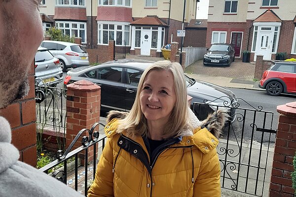 Julia Potts speaking to a resident on a doorstep in Thornhill